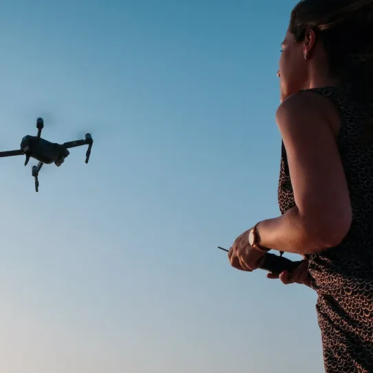 A girl flying a drone